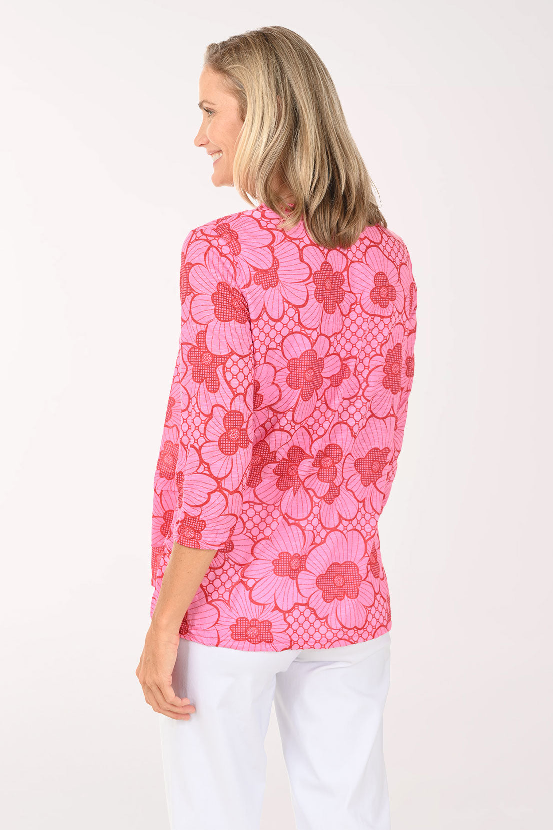 Woman wearing a pink 3/4 sleeve v-neck top