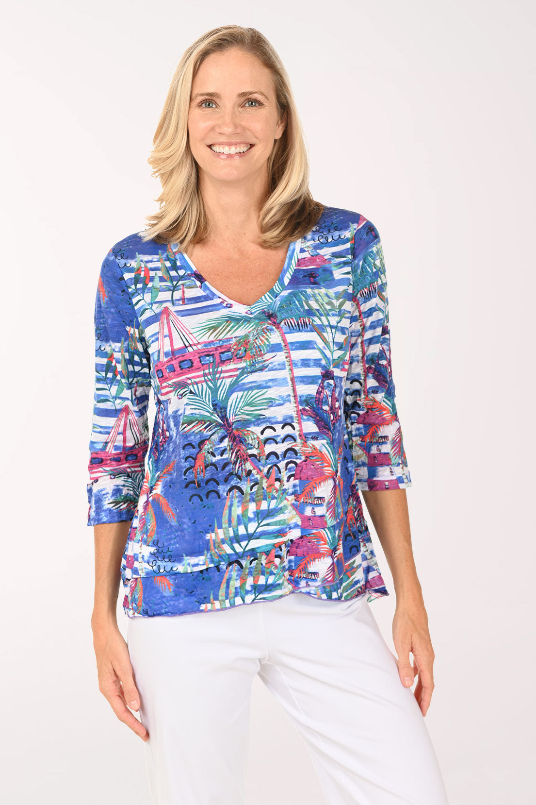Woman wearing a colorful patterned blouse on a white background