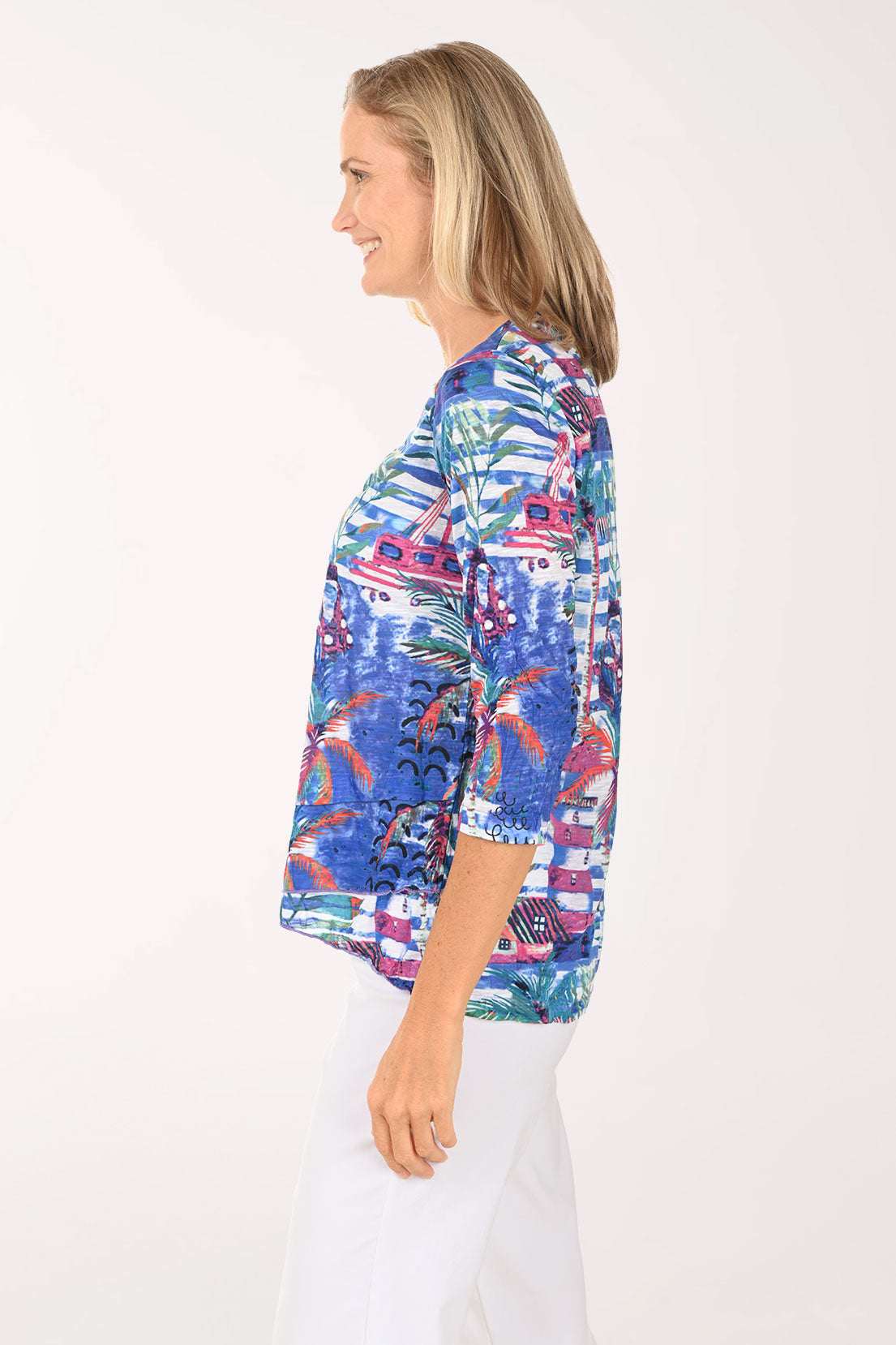 Woman wearing a colorful patterned blouse on a white background