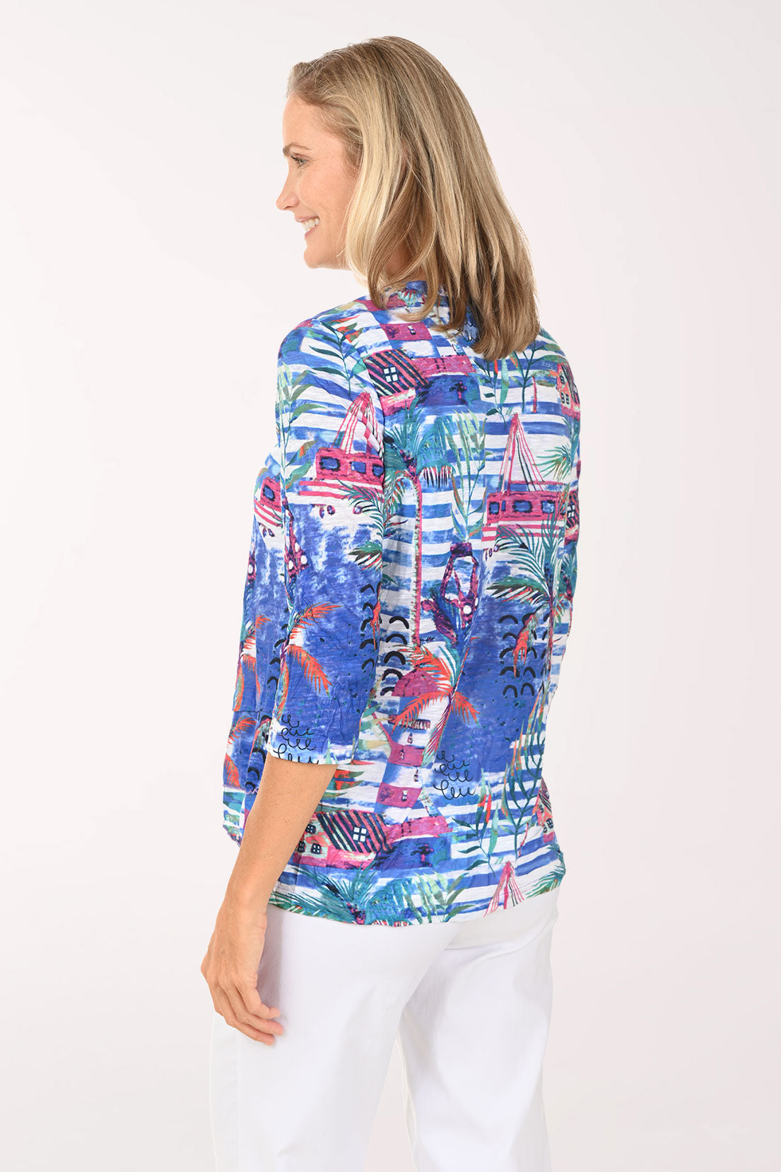 Woman wearing a colorful patterned blouse on a white background