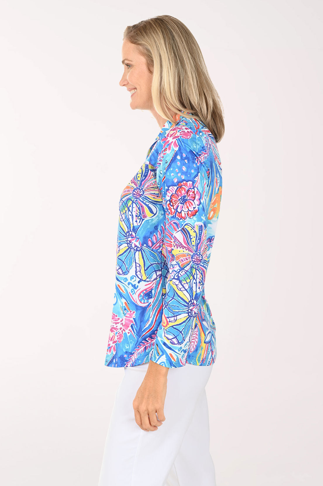 Woman wearing a multi floral quarter zip-up top
