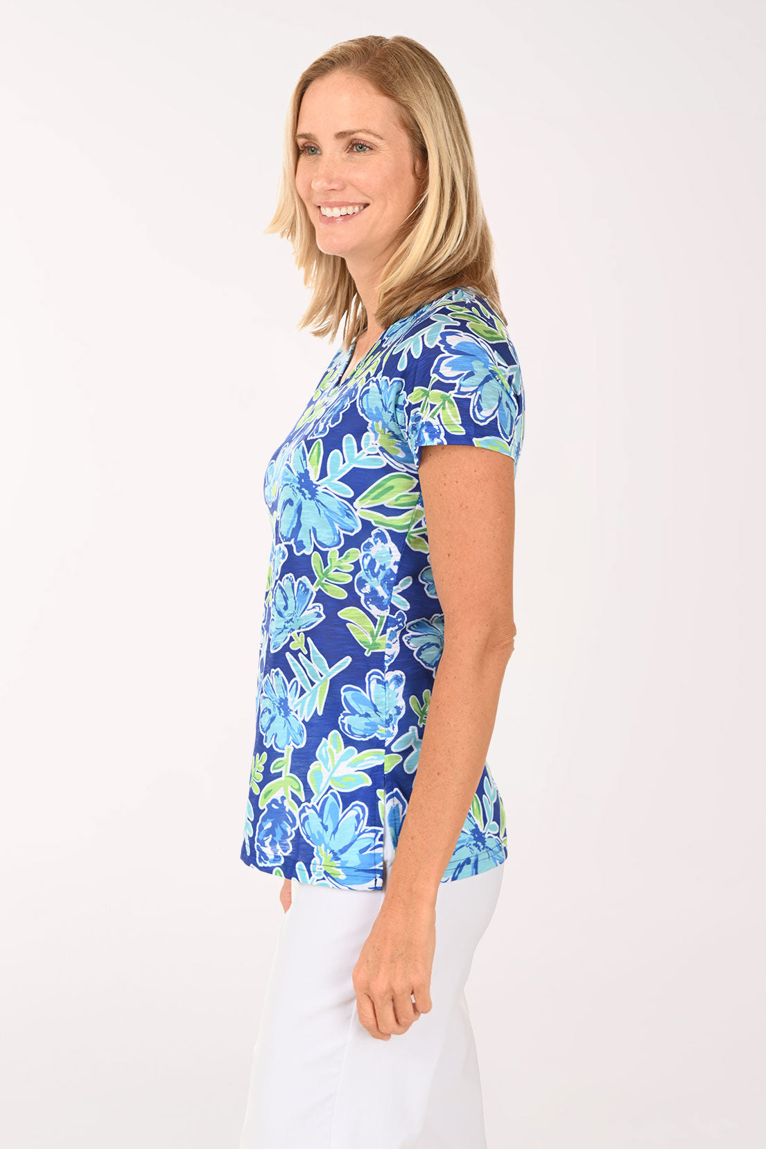 Woman wearing a blue and green top with hydrangeas on it