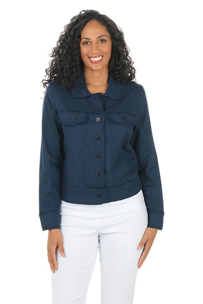 Woman wearing a navy blue jacket and white pants on a white background