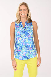 Woman wearing a colorful sleeveless top with a white background