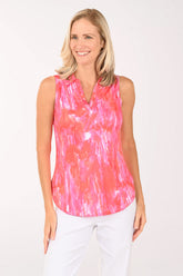 Woman wearing a pink tie-dye sleeveless top on a white background