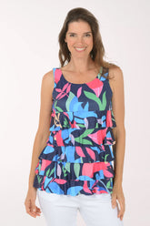 Woman wearing a colorful floral tiered tank top on a white background
