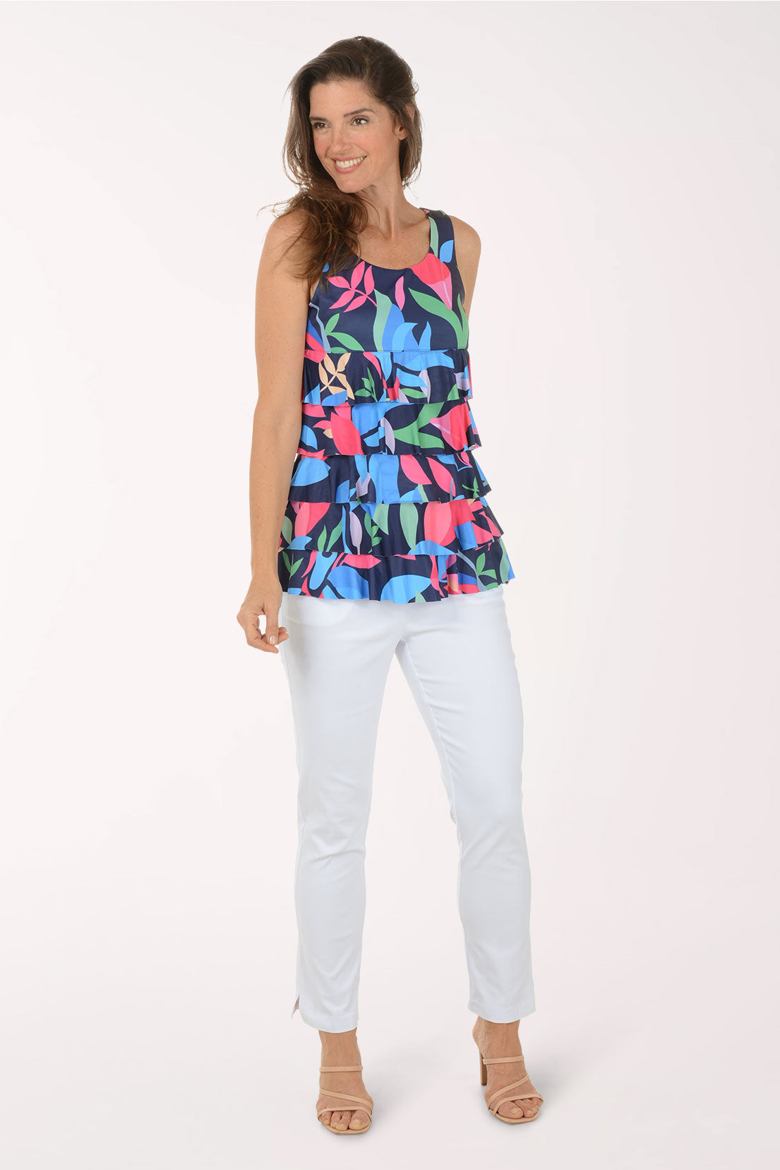 Woman wearing a colorful floral tiered tank top on a white background