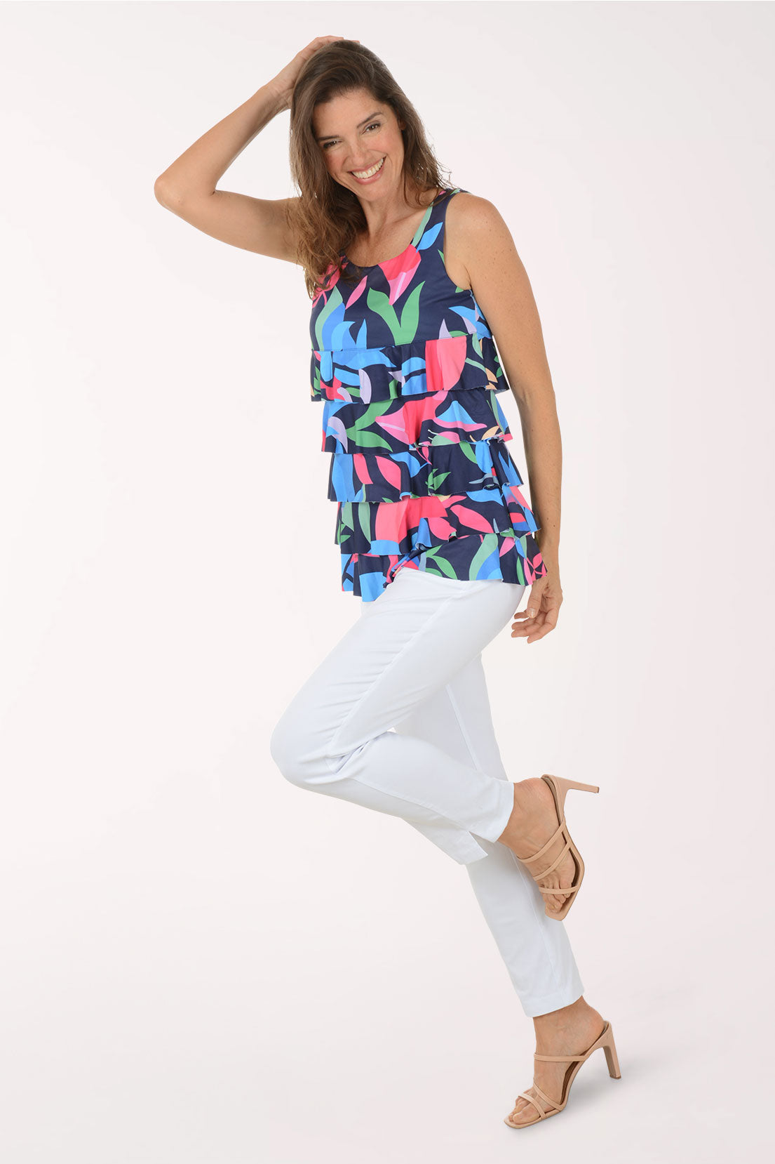 Woman wearing a colorful floral tiered tank top on a white background