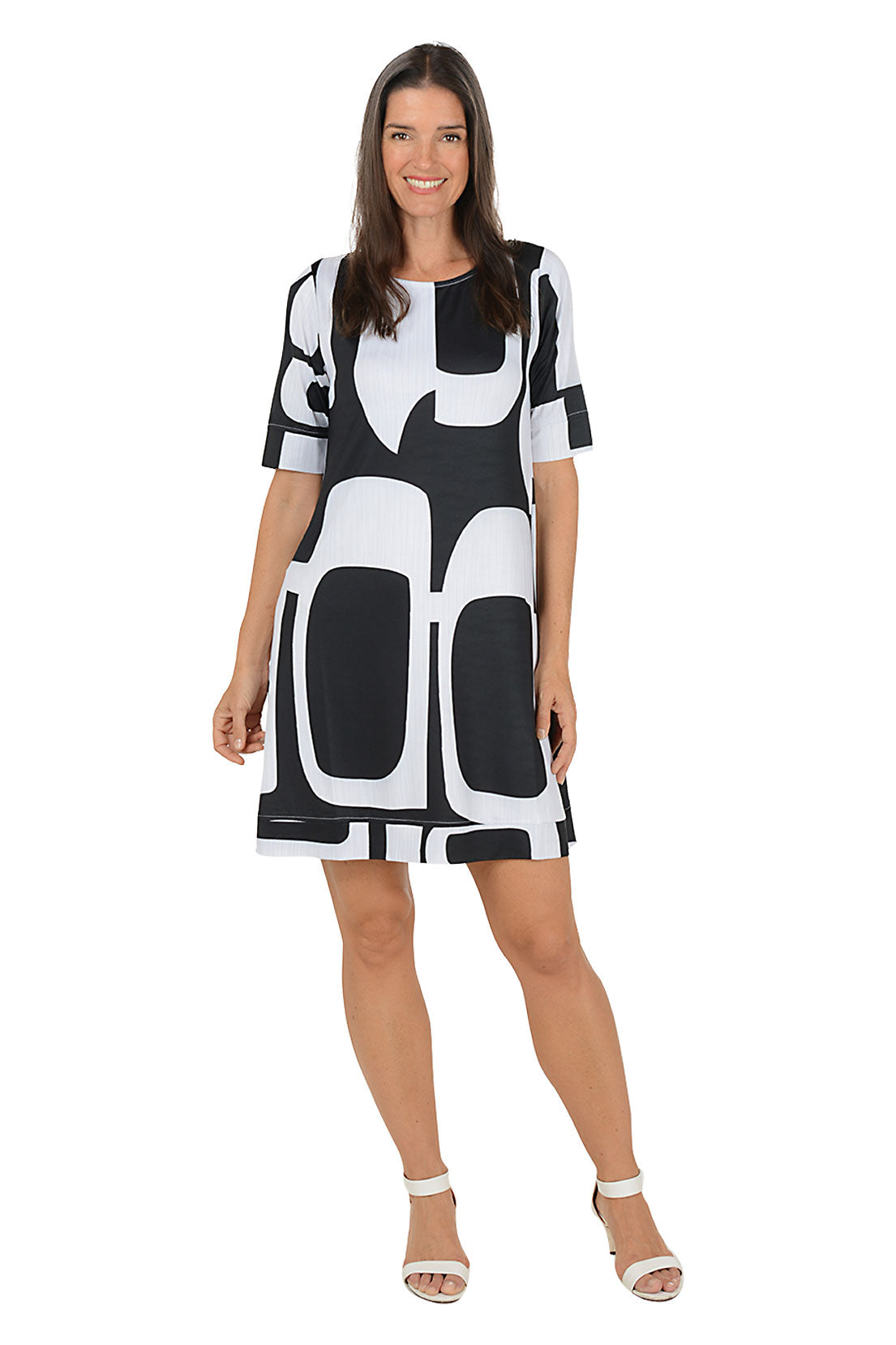 Woman wearing a 3/4 sleeve black and white abstract patterned swing dress on a white background.