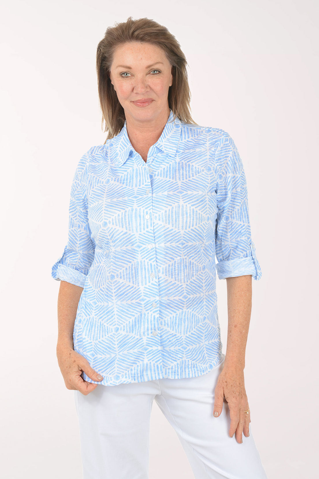 Woman wearing a light blue patterned shirt on a white background
