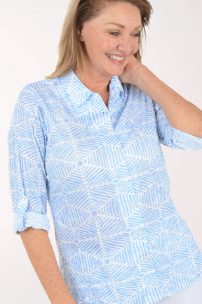 Woman wearing a light blue patterned shirt on a white background