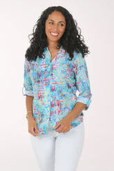 Woman wearing a colorful patterned shirt on a white background