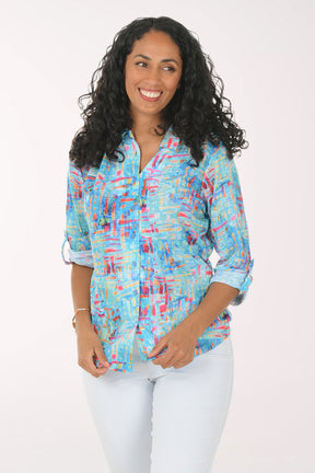 Woman wearing a colorful patterned shirt on a white background