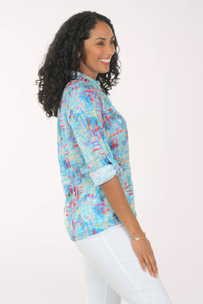 Woman wearing a colorful patterned shirt on a white background