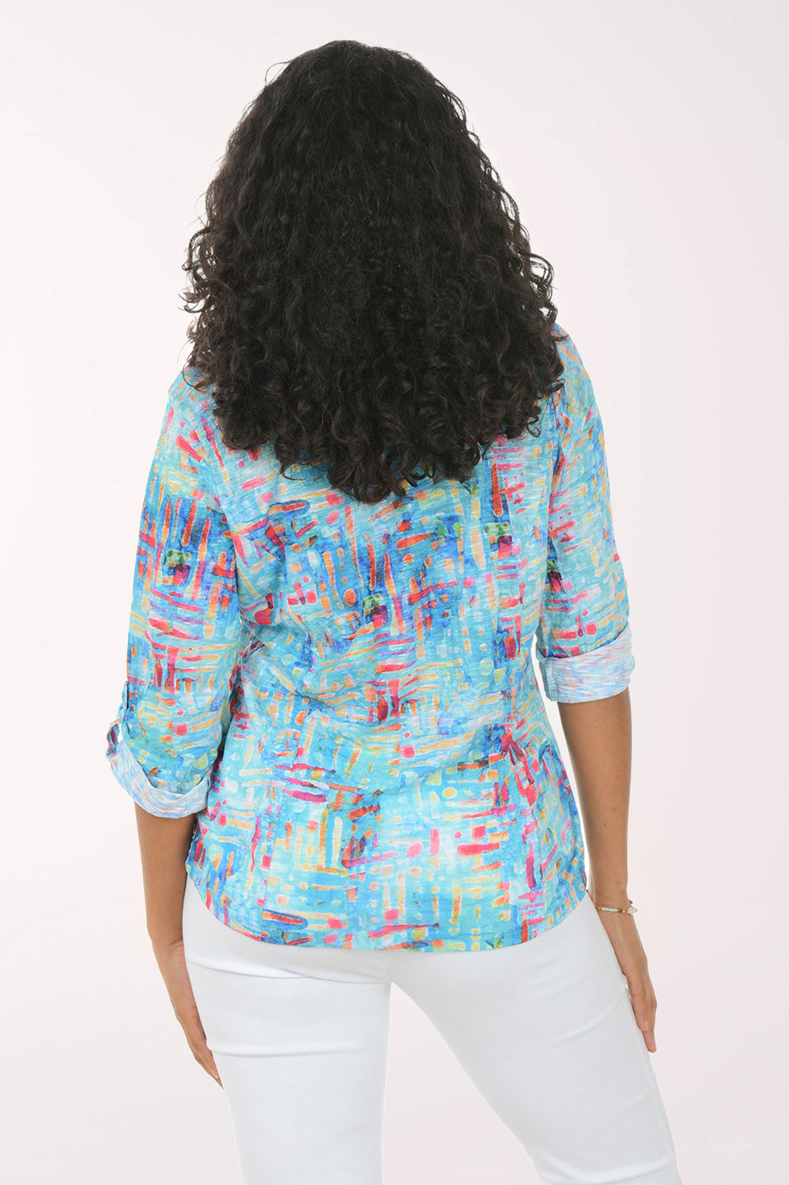 Woman wearing a colorful patterned shirt on a white background