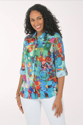 Woman wearing a colorful patterned shirt on a white background