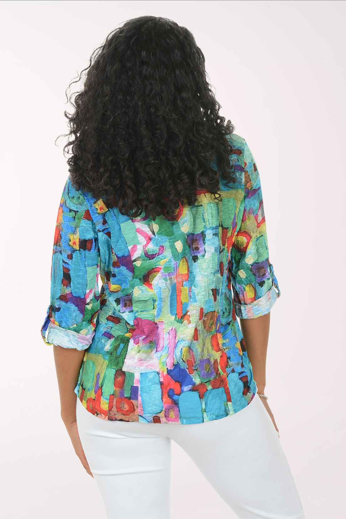 Woman wearing a colorful patterned shirt on a white background
