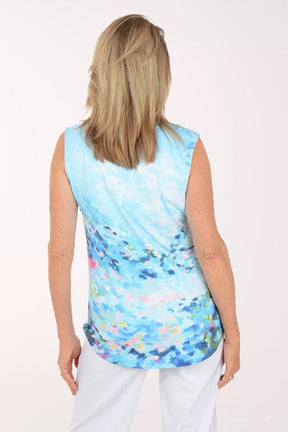 Woman wearing a sleeveless, multicolored top with a white background