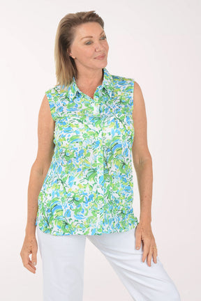 Woman wearing a sleeveless floral blouse with a white background