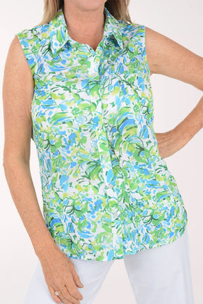 Woman wearing a sleeveless floral blouse with a white background