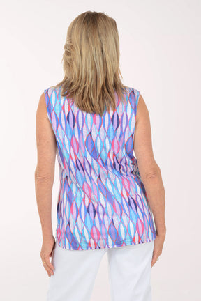 Woman wearing a sleeveless multicolored patterned top on a white background
