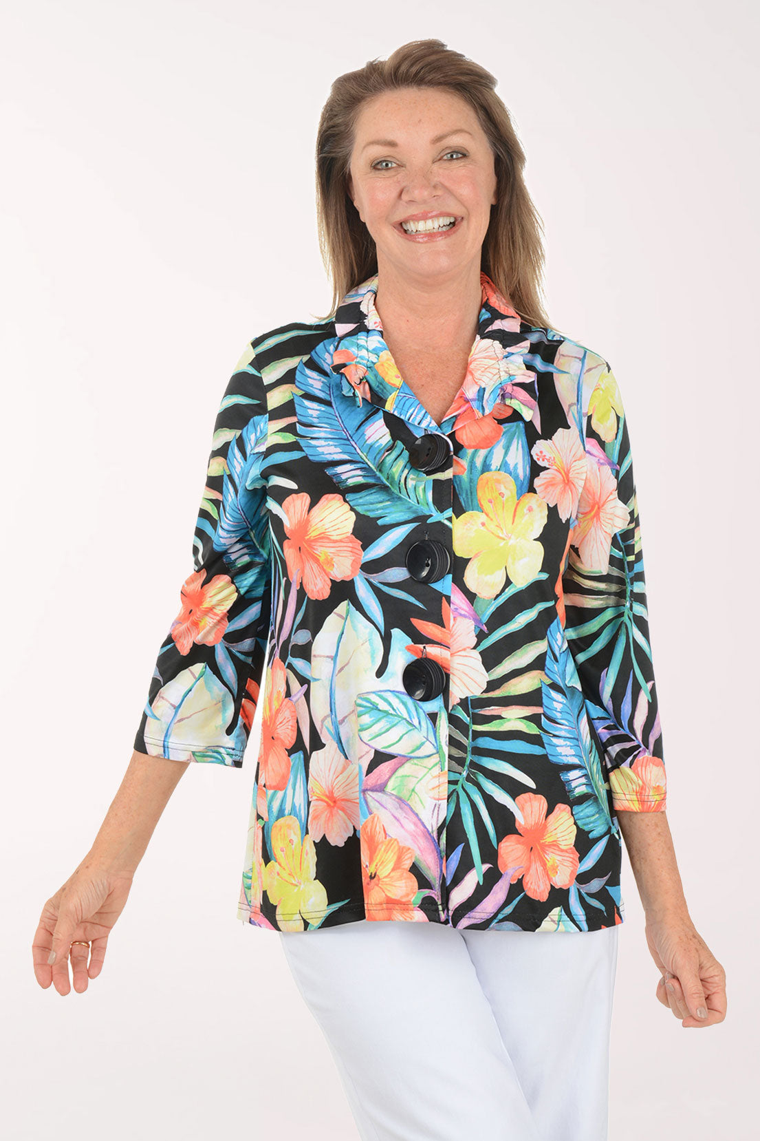Woman wearing a colorful floral blouse on a white background