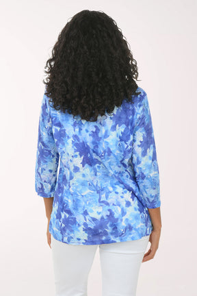 Woman wearing a blue floral blouse against a white background