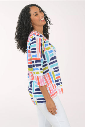 Woman wearing a colorful striped shirt on a white background