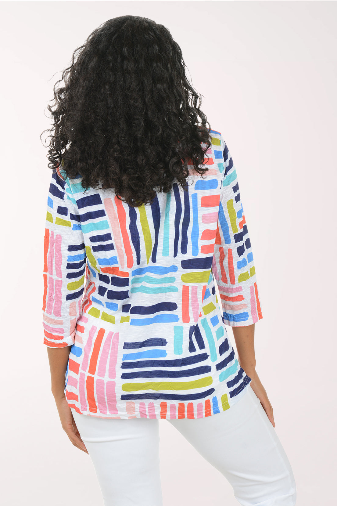 Woman wearing a colorful striped shirt on a white background