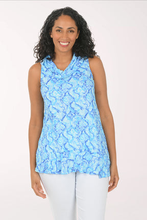 Woman wearing a blue patterned sleeveless top on a white background