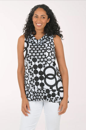 Woman wearing a sleeveless black and white patterned top on a white background