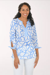 Woman wearing a blue patterned blouse on a white background