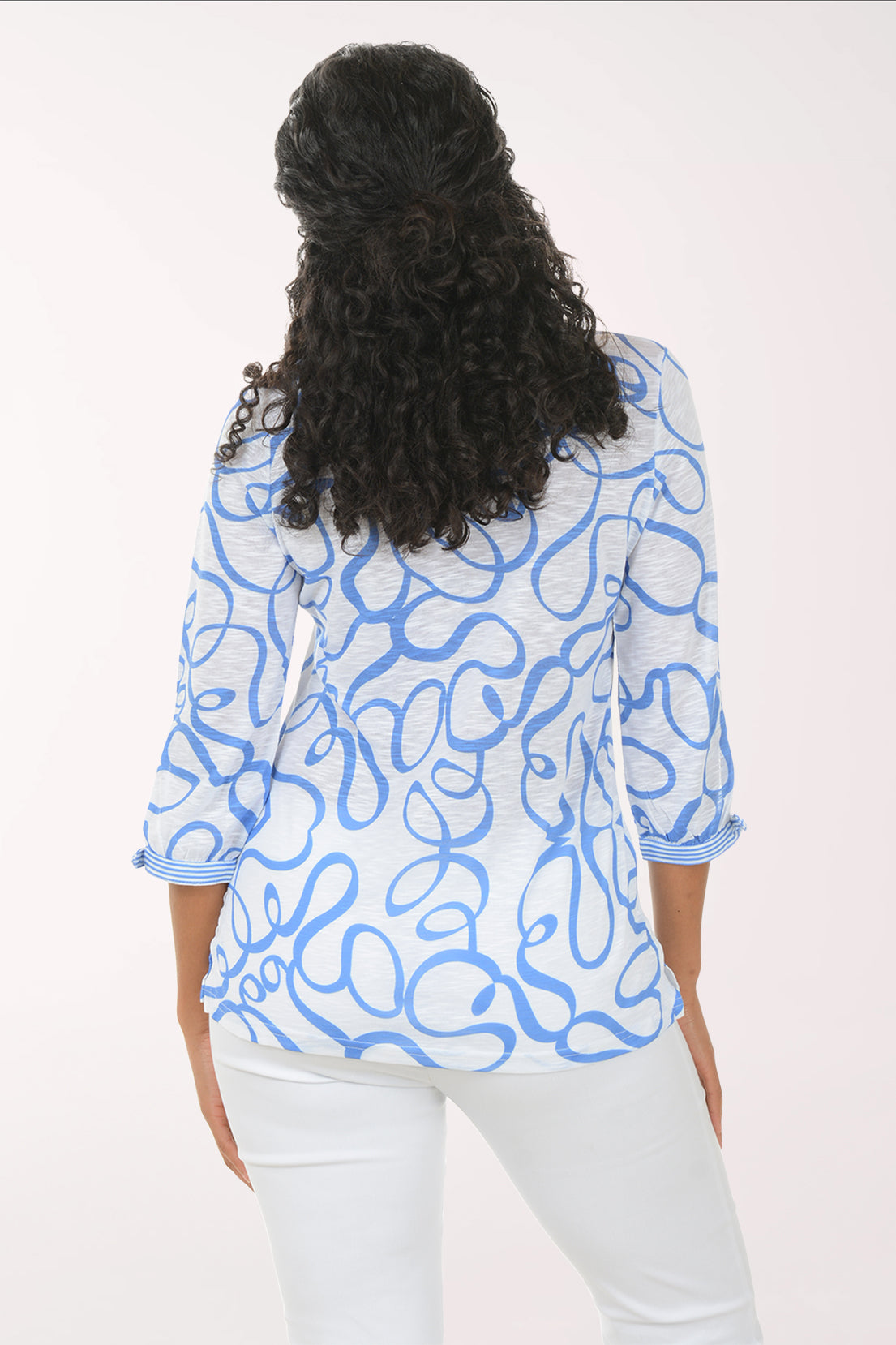 Woman wearing a blue patterned blouse on a white background