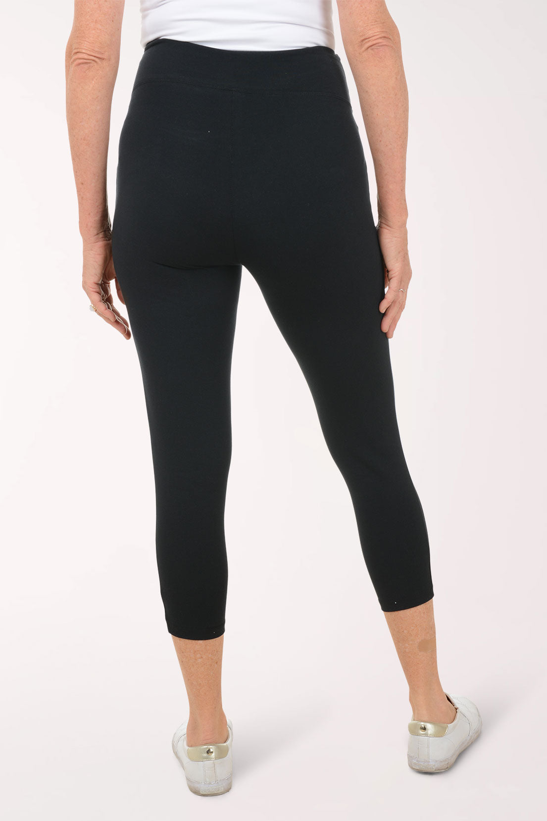 A woman wearing black leggings.