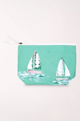 Seafoam green zip-top cosmetics pouch printed with large white and green sailboats, with a white zipper pull.