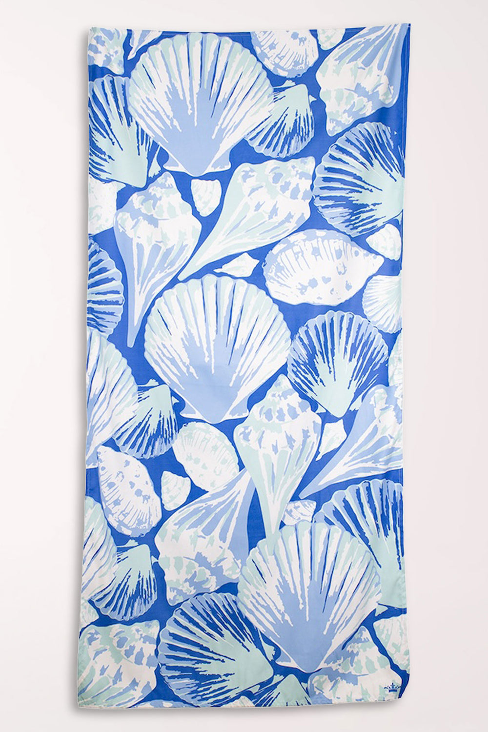 Microfiber beach towel with an all-over print of scallop and other seashells in white and periwinkle on a bright sapphire blue background.