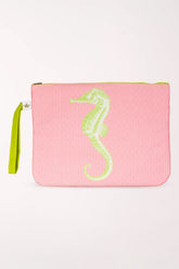 Pink textured wet/dry bag with a lime green seahorse on the front and a lime green wrist strap.