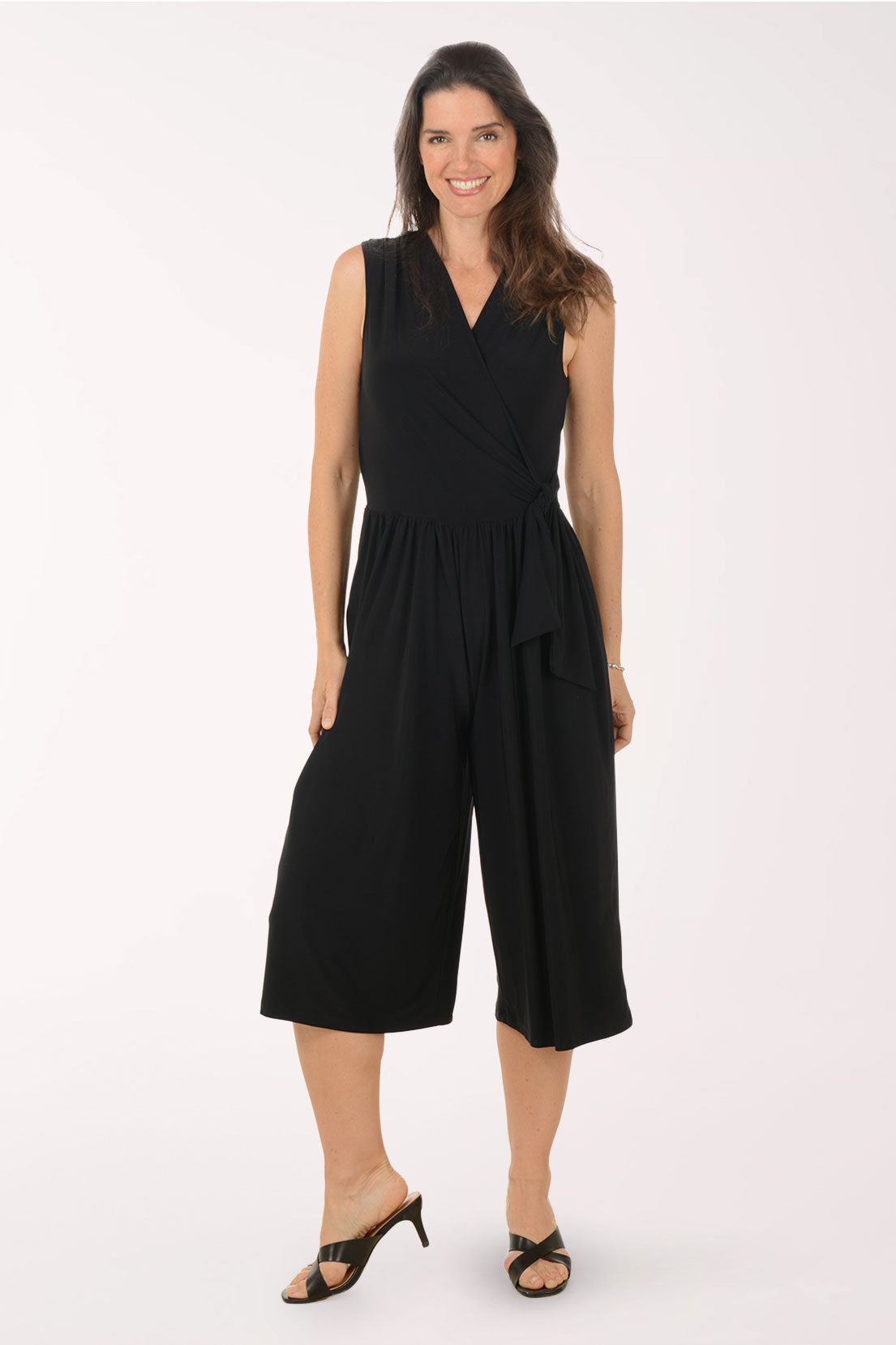 Woman wearing a black jumpsuit on a white background