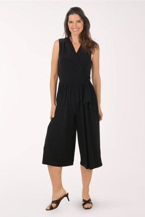 Woman wearing a black jumpsuit on a white background