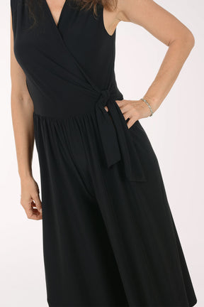 Woman wearing a black jumpsuit on a white background