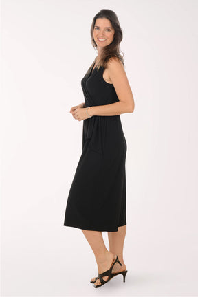 Woman wearing a black jumpsuit on a white background