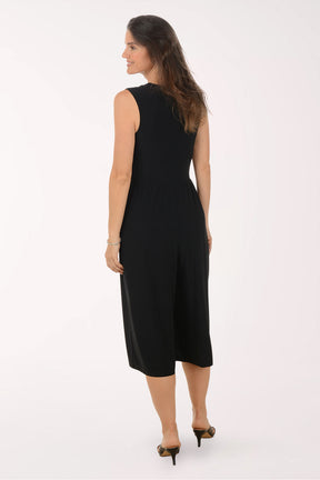 Woman wearing a black jumpsuit on a white background