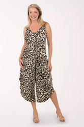 Woman wearing a leopard print jumpsuit on a white background