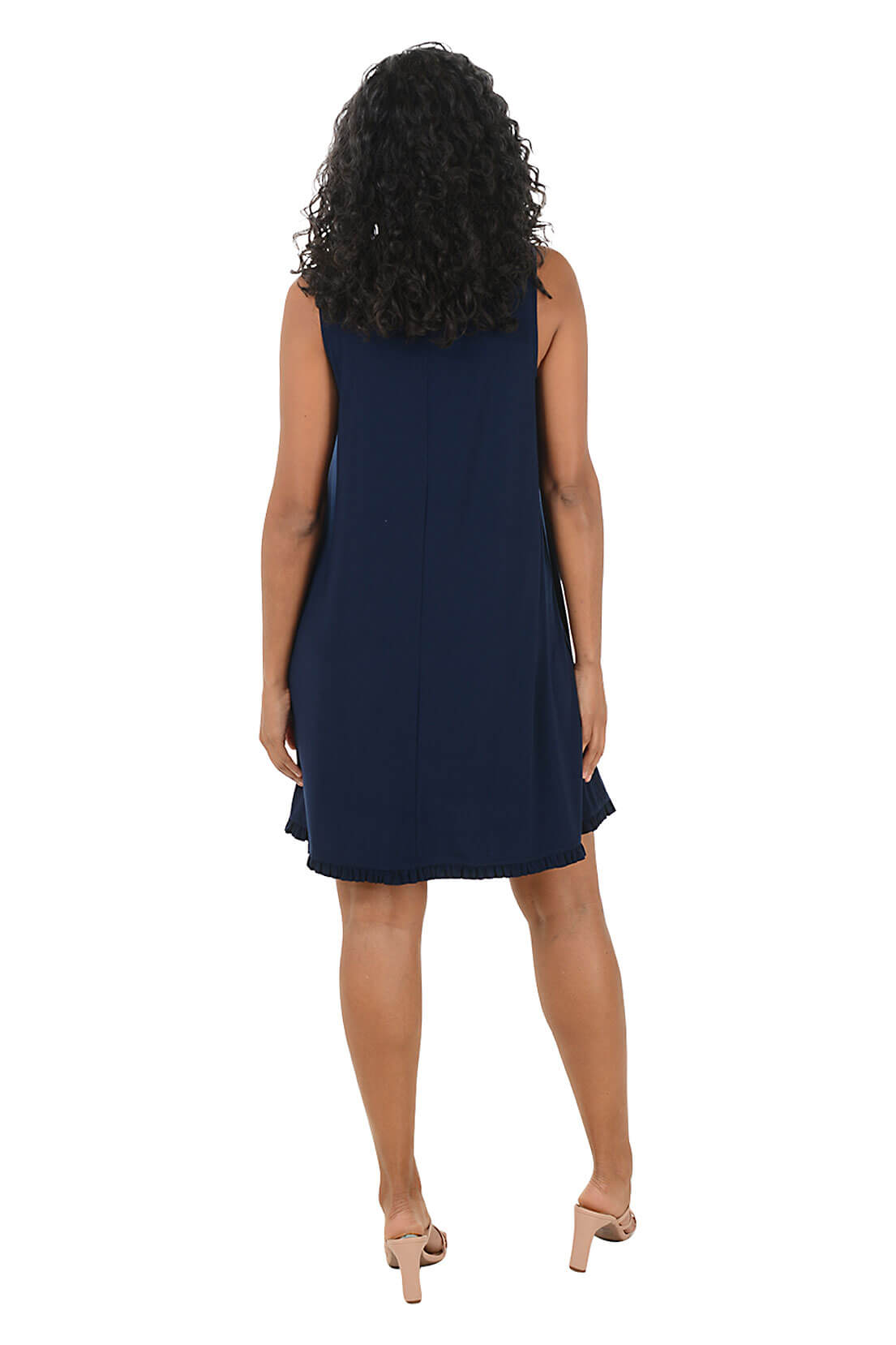 Woman wearing a navy blue sleeveless dress on a white background. Back shot