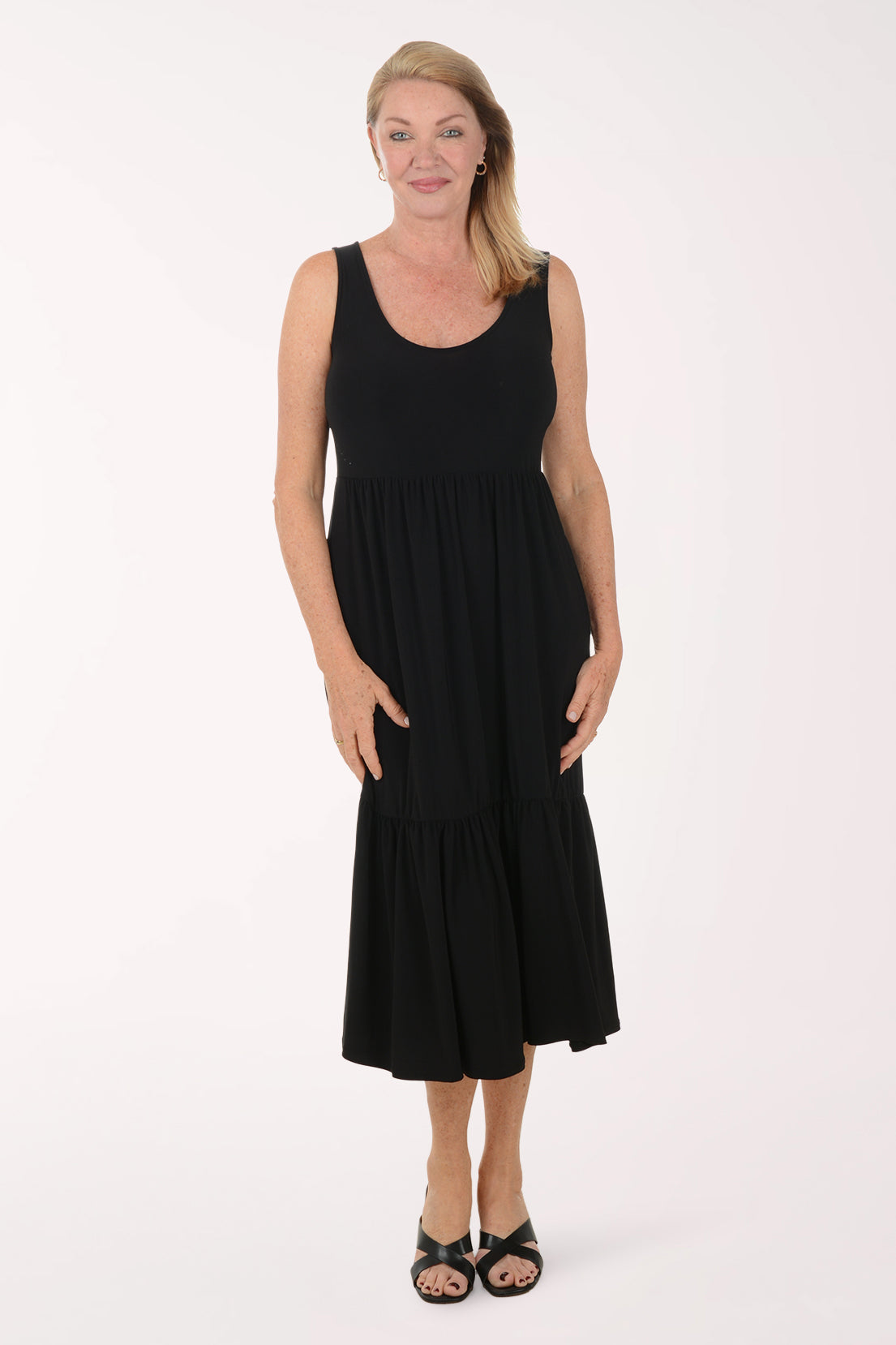 Woman wearing a black sleeveless dress on a white background