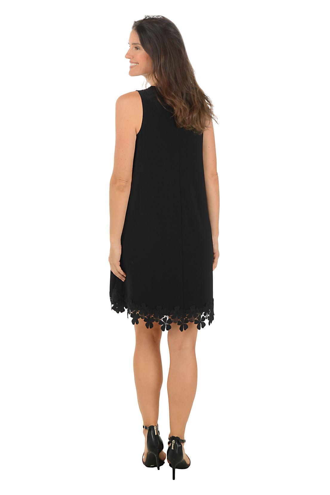 Woman wearing a black dress with floral details on a white background