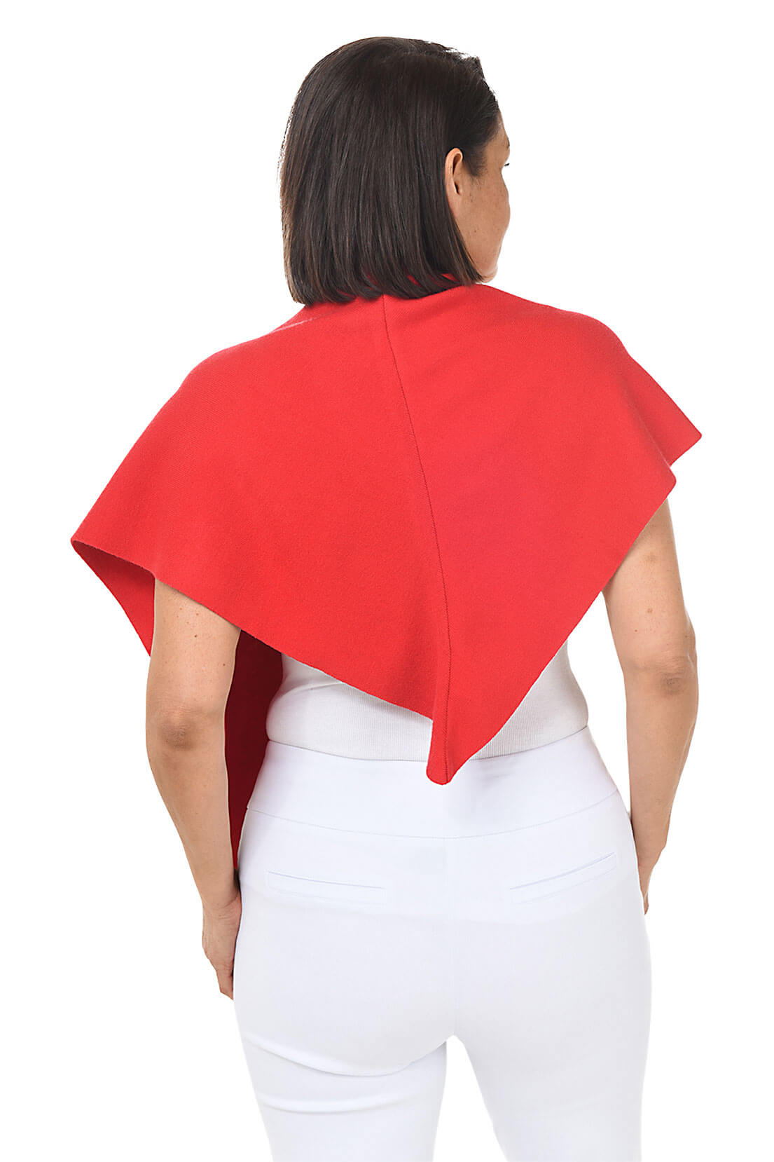 A woman wears a red wrapped shawl over a white top and pants against a white background. Back shot.
