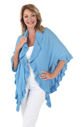 A woman wearing a opal blue open front wrap sweater with ruffled rib-knit trim over a white top and white pants.