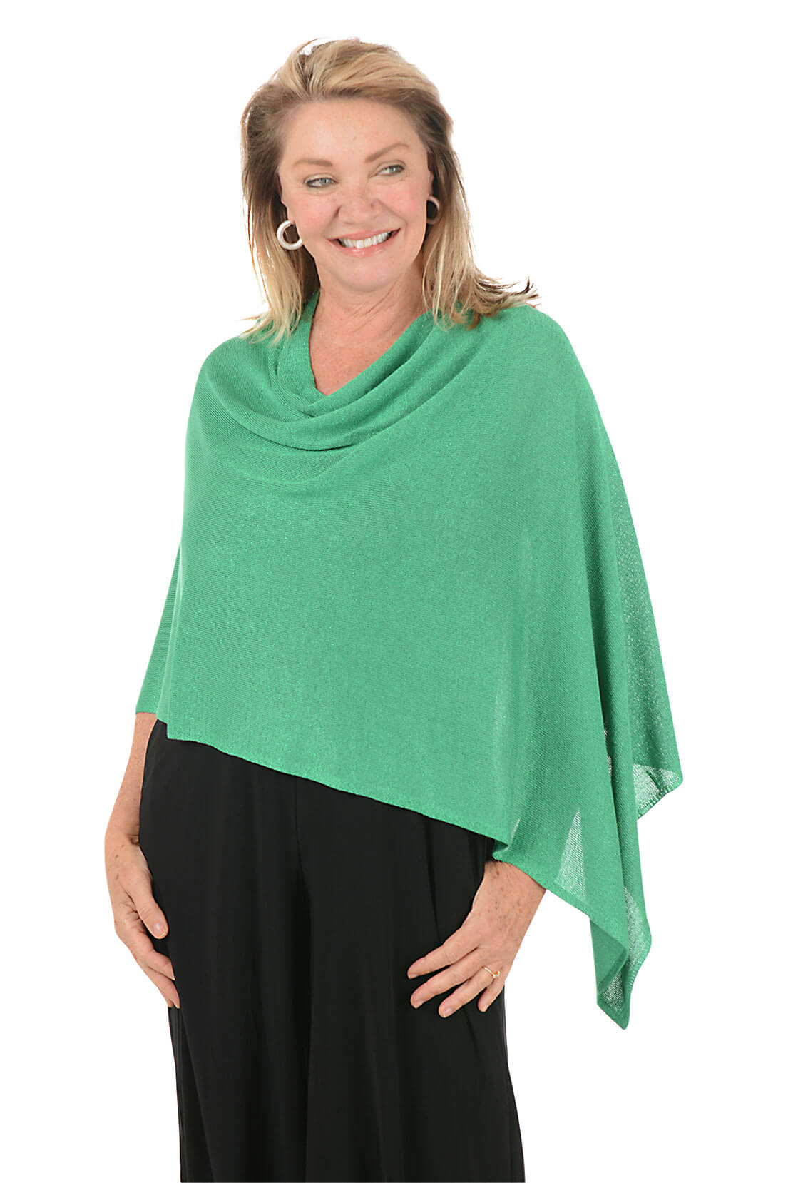 Woman wearing a metallic green poncho against a white background