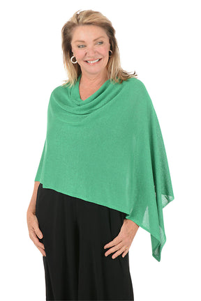 Woman wearing a metallic green poncho against a white background